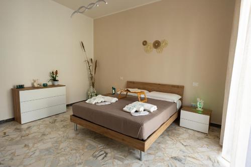 a bedroom with a bed with towels on it at Colè House in Bitetto