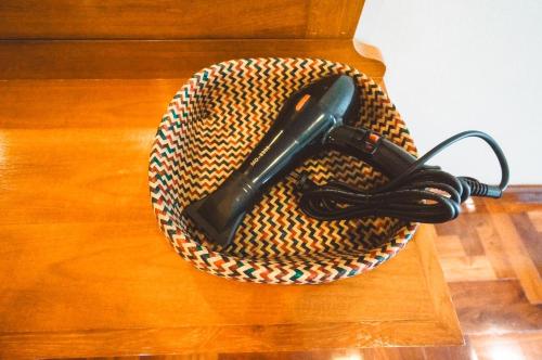 a dog mennel with a leash in it on a wooden floor at Chez Moi Bangkok Private Executive Residence Sukhumvit 26 in Khlong Toei