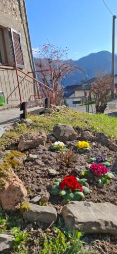 a garden with flowers and rocks in front of a building at La Dimora di Beatrice in Santa Brigida