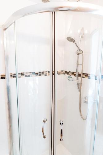 a shower with a glass enclosure in a bathroom at Fairview House in Sheringham