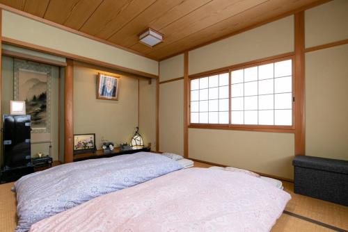 a bedroom with a large bed and a window at Houtouji Temple in Yoshino