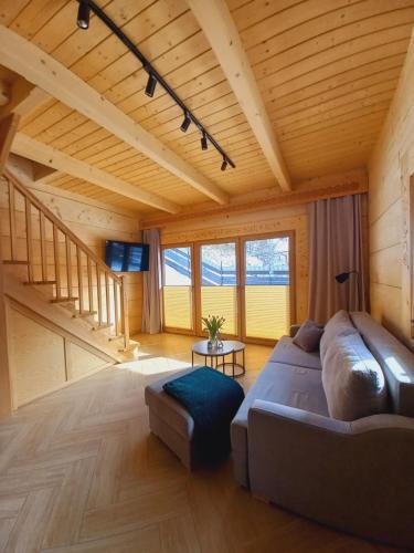 a living room with a couch and a table at Domek z bali Zakopane in Zakopane