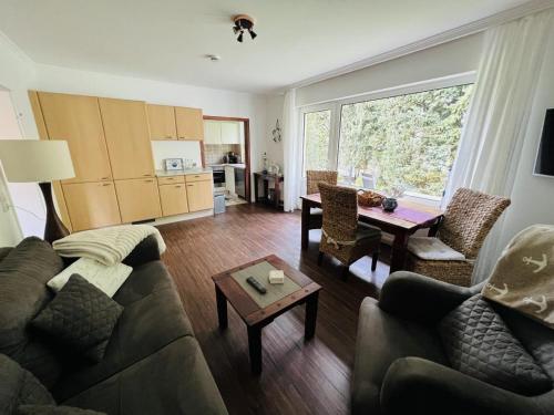 a living room with a couch and a table at Haus Larum App. 3 in Scharbeutz