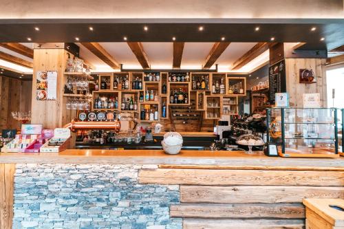 a bar in a restaurant with a stone counter at Serendipity Hotel in Sauze dʼOulx