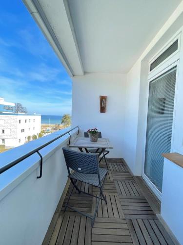 a balcony with a table and a chair on it at Nellie´s Nest in Scharbeutz