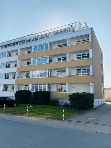 an apartment building with a parking lot in front of it at Nellie´s Nest in Scharbeutz