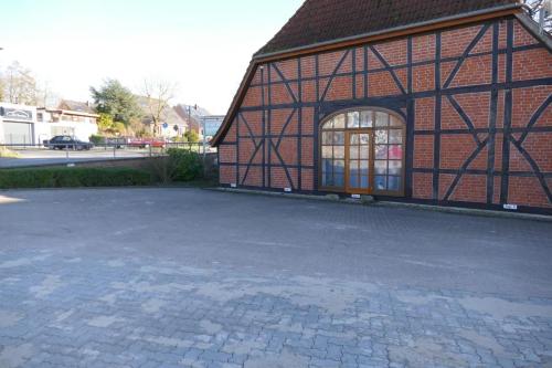 a large brick building with a large window on it at Landhaus am See App. 2 in Pönitz am See