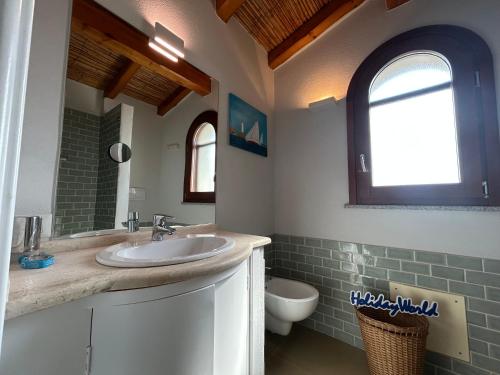 a bathroom with a sink and a toilet at Casa Giumagio by Holiday World in Posada