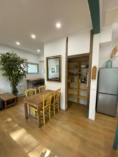 une salle à manger avec une table et un réfrigérateur dans l'établissement T3 atypique au rez de chaussée, à Ramonville-Saint-Agne