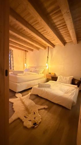 a room with two beds and a towel on the floor at Lo Chalet Incantato del Maso K in Folgaria