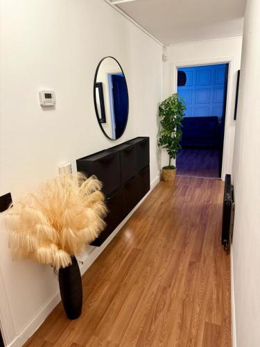 a living room with a mirror and a table at 2 Bedroom Apartment near Glasgow City Centre, Celtic Park and Emirates Arena in Glasgow