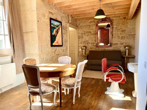 a living room with a wooden table and chairs at Château d'Aynac in Aynac
