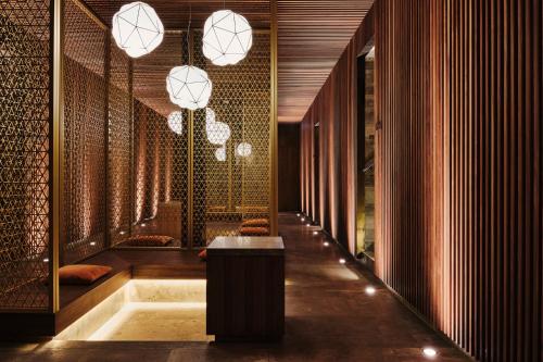 a hallway with a table and chandeliers at Clubhaus Bachmair Weissach in Tegernsee