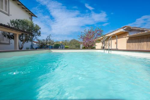 a swimming pool in a house with blue water at Borgo House In Florentine Hills With Pool in Fucecchio