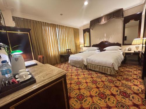 a hotel room with a large bed with a large mirror at Royal Seasons Hotel Taipei ‧ Nanjing W. in Taipei