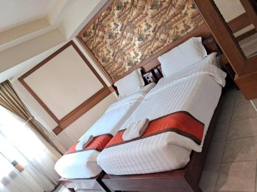 Postel nebo postele na pokoji v ubytování Boutique Paradise Hotel