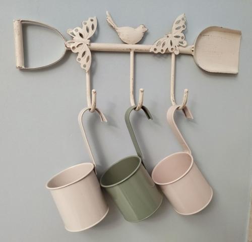 a group of coffee cups hanging on a wall at Casa vacanze Vista Castello in Oria