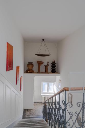 a hallway with a staircase with a light fixture at La Résidence de l'Orangerie in Strasbourg