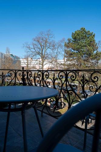 a metal fence with a table on a patio at La Résidence de l'Orangerie in Strasbourg