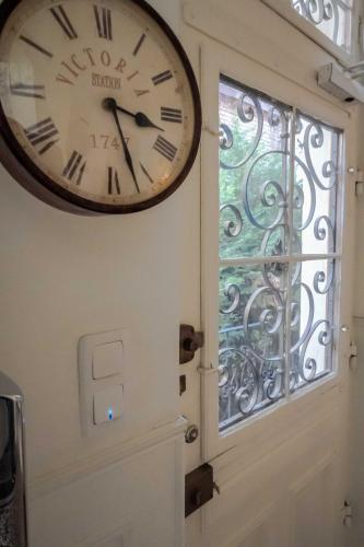 a clock on the wall next to a door at La Résidence de l'Orangerie in Strasbourg