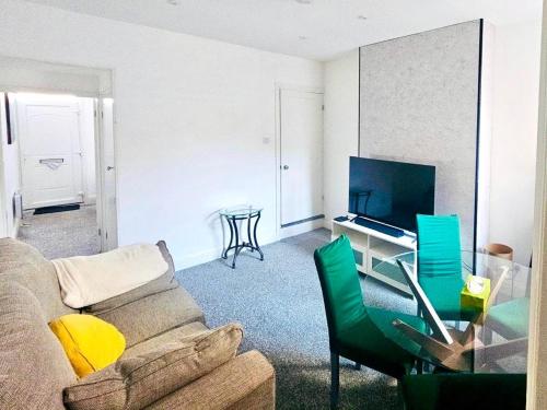 a living room with a couch and a table at Cozy Haven near Glenfield & LRI Hospitals in Leicester