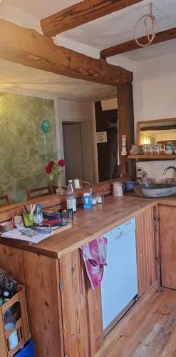 a kitchen with a wooden counter top with a dishwasher at Gemütliches Fachwerkhaus in Reinhausen
