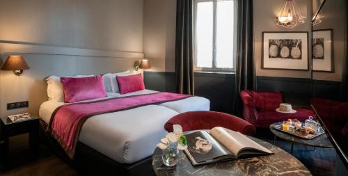 a hotel room with a bed and a table at Best Western Plus Nice Cosy Hotel in Nice
