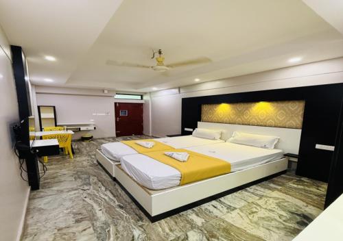a large bedroom with a large bed and a desk at Century Residency & Conference Hall - Manjeri in Malappuram