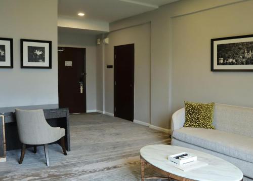 a living room with a couch and a table at The Chateau Spa & Wellness Resort in Bukit Tinggi