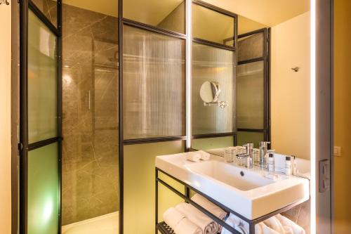 a bathroom with a sink and a shower at Pestana Collection Plaza Mayor in Madrid