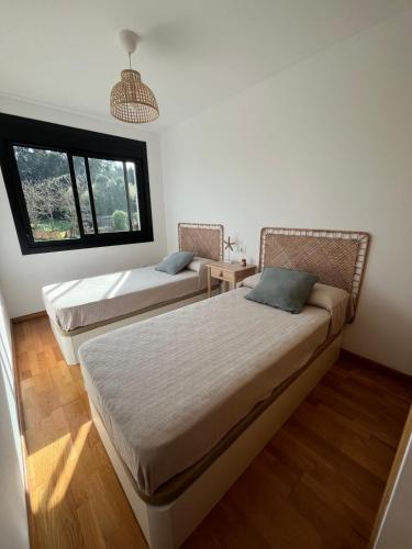 Katil atau katil-katil dalam bilik di Acogedor playa grande Miño