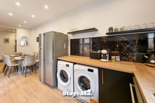 a kitchen with a washer and dryer in a room at Clarence Co-living - Private Room Self-cater in Manchester