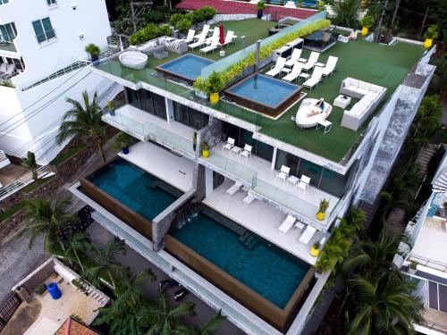 an aerial view of a house with two swimming pools at Villa Momo Private Pool near Kata Beach in Kata Beach