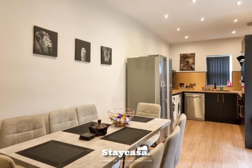 a kitchen with a table and chairs in a room at Clarence Co-living - Private Room Self-cater in Manchester