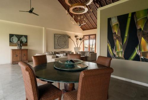 a dining room with a table and chairs at OMEKAI Cemagi by Nakula in Canggu