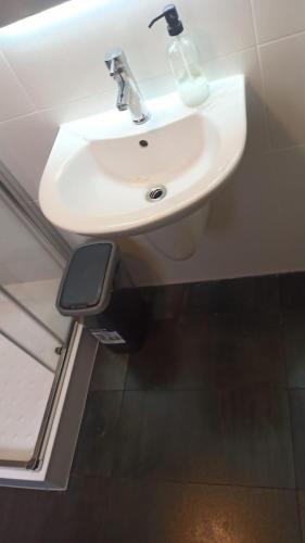 a white sink in a bathroom with a mirror at Flat 1 Central Apartment in Swieqi in Is-Swieqi
