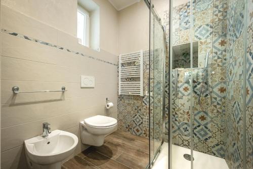 a bathroom with a toilet and a glass shower at Incanto Manarola in Manarola