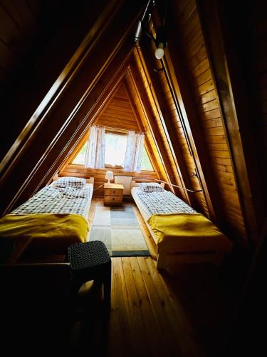 a room with two beds in a attic at Bacówka w Karkonoszach - Domek na wyłączność w Karpaczu blisko wyciągu i szlaków in Karpacz