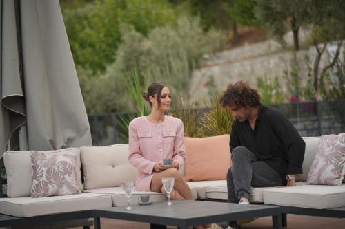 a man and a woman sitting on a couch at Ramitos Hotel in Turunc