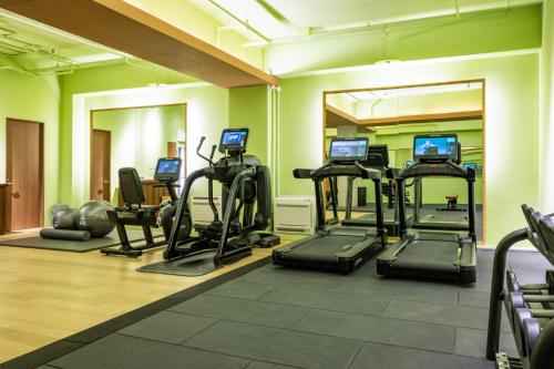 a gym with several tread machines in a room at Gora Kadan in Hakone