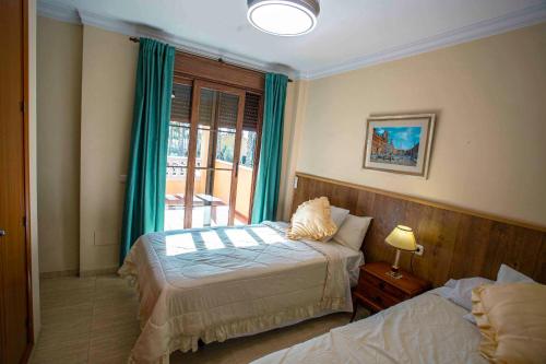 En eller flere senge i et værelse på Villa Ilusión Home