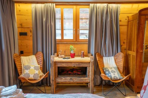 a room with two chairs and a wooden table with at Chalet Schuler in Zermatt