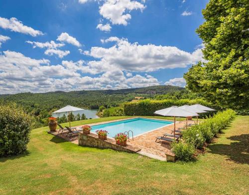 a swimming pool with a view of a lake at Agriturismo Tenuta il Tasso in Rapolano Terme