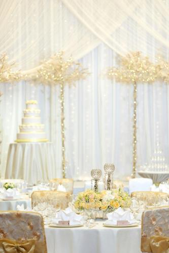 a white table with a wedding cake on top of it at Sheraton Towers Singapore Hotel in Singapore