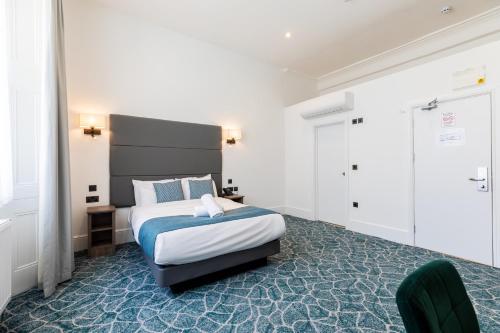 a hotel room with a bed and a chair at The J Hyde Park Hotel in London