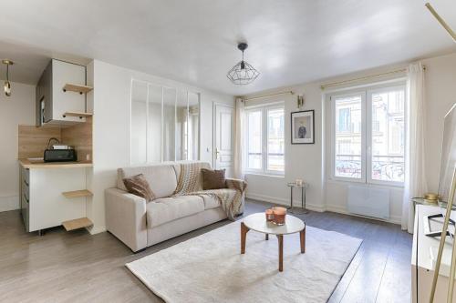 un salon avec un canapé et une table dans l'établissement Appartement de Charme rue Lafayette 4P-1BR, à Paris