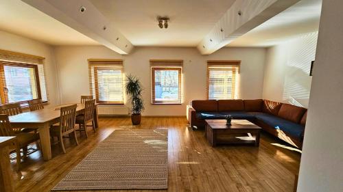 a living room with a couch and a table at Villa Velora - luxury & wellness in Odorheiu Secuiesc