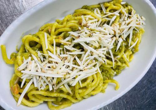 a white plate of pasta with cheese on it at Agri-alloggio le Poscole Al Canton in Castelgomberto