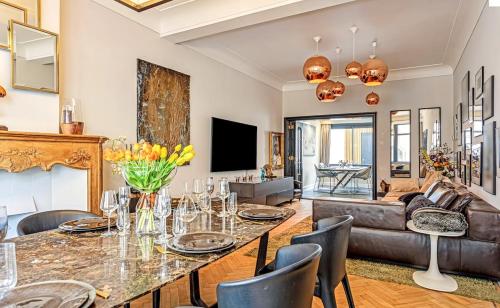 a living room with a table and a couch at Luxe city villa te Hasselt in Hasselt