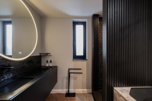 a bathroom with a large mirror and a sink at Luxe city villa te Hasselt in Hasselt